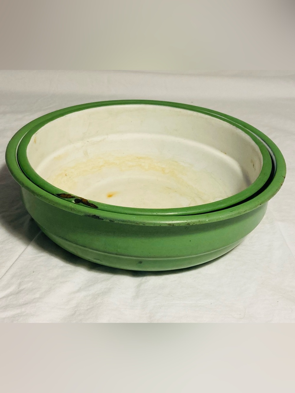 Vintage enamelware pair of nesting bowls in mint green off white interior
